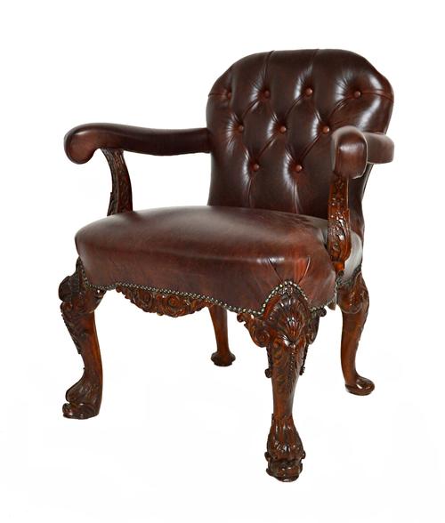 A mid 18th century style mahogany framed leather button upholstered open armchair, on shell capped cabriole supports and serpent feet.  Illustrated