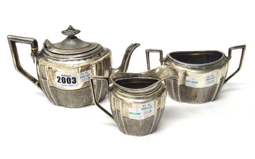 A Victorian silver three piece tea set, comprising;  a teapot, a twin handled sugar bowl and a milk jug, each piece of shaped oval form, with partly f
