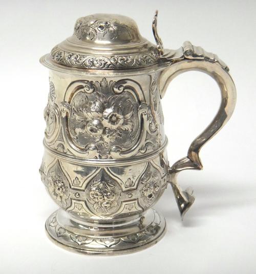 A George III silver tankard of baluster form, with later embossed decoration, London 1784, by Hester Bateman, 19cm high.