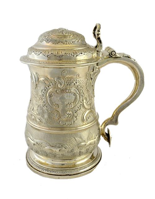 A George II silver hinge lidded tankard, of baluster form, later decorated with hunting scenes, presentation inscribed, London 1742, 23cm high, gross