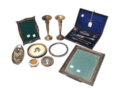 Silver and silver mounted wares, comprising; a lady's manicure set, cased, six photograph frames and mounts, a pair of trumpet shaped vases and an ova