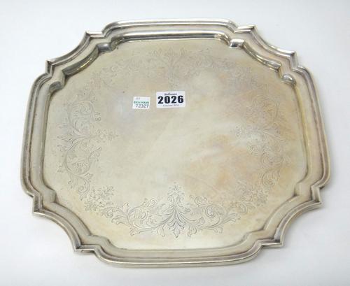 A Canadian silver salver of shaped square form, engraved with foliate and scroll decoration, gross weight 860gms, 30.5cm wide.
