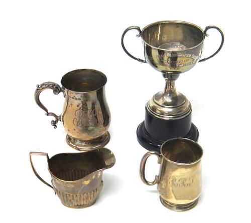 Silver, comprising; a baluster shaped christening mug, having a scrolling handle and on a circular foot, by Elkington & Co, Birmingham 1936, a smaller