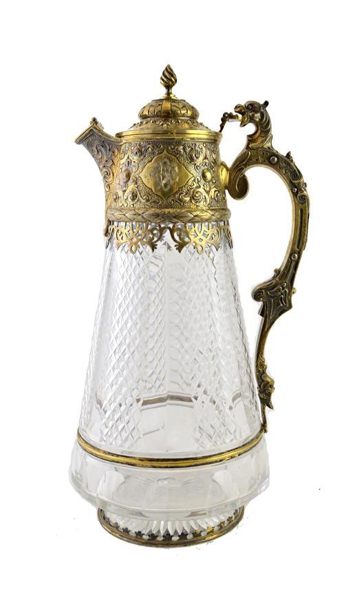 A Victorian cut glass claret jug with chased silver gilt mounts, crest and motto inscribed, London 1878, by Charles Edwards, 29.5cm high.  Illustrated