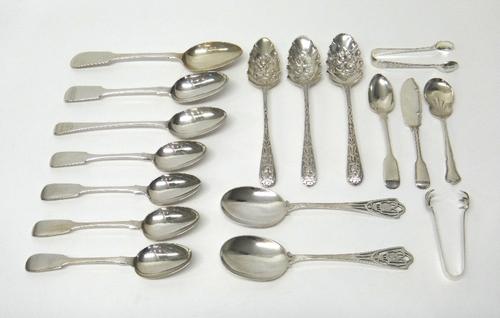 Silver table flatware, comprising; a pair of serving spoons, London 1907, three fruit serving spoons, the handles and the bowls decorated with masks,