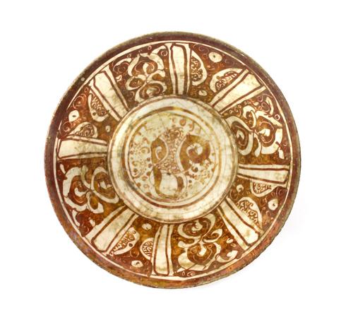 A silver three piece tea set, comprising; a teapot, a twin handled sugar bowl and a milk jug, each piece of squat shaped circular form, with partly fl