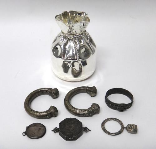 An Islamic octagonal hinge lidded box, with engraved decoration and fitted with pierced handles, two Eastern torque style bangles, another Eastern ban