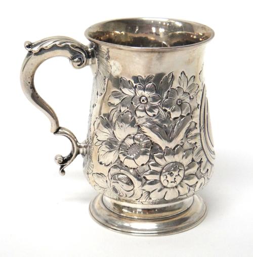 A George III silver mug of baluster form, with later embossed decoration, London 1770, 10.5cm high, gross weight 215gms.