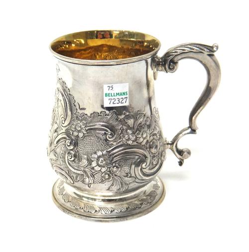 A George II silver mug, with later embossed floral decoration and presentation inscription, London 1759.