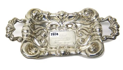 A Danish shaped rectangular twin handled basket, with scroll and spiral fluted decoration, presentation inscribed to the centre and raised on four pad