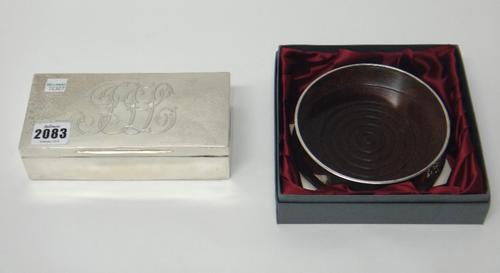A silver cigarette box of plain rectangular form, the cover engraved with a monogram, London 1895, together with a modern silver mounted bottle coaste