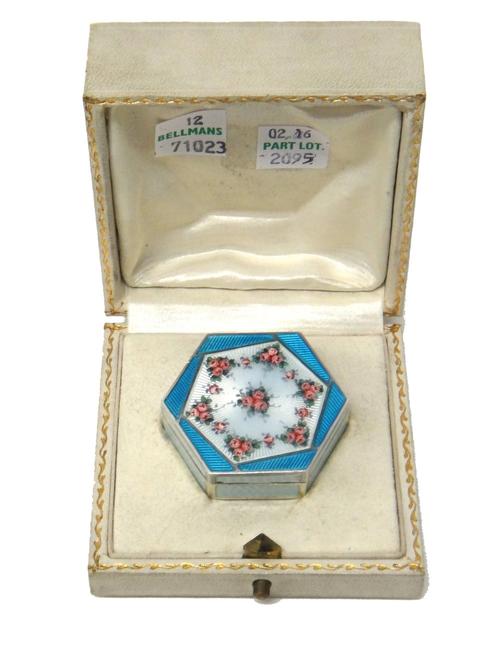 A silver and enamelled hexagonal box and cover, European circa 1930, the lid decorated with pink floral sprays, on an engine turned pale blue enamelle
