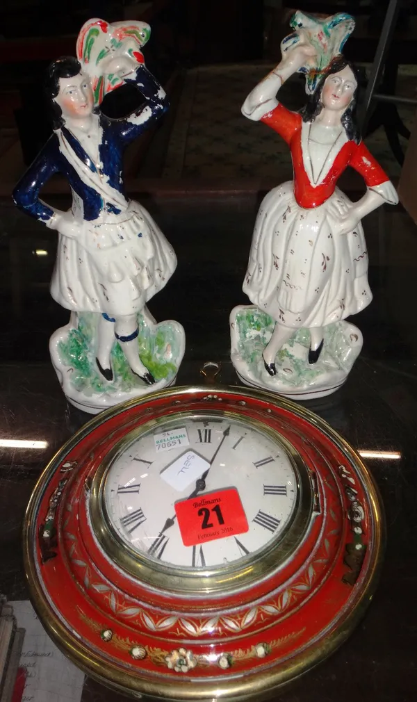 A pair of Staffordshire figures and a circular wooden and brass wall clock.