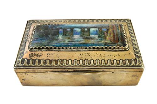 A Liberty & Co silver and enamelled rectangular hinge lidded box, the cover mounted with an enamelled plaque, depicting a bridge scene with trees, wit