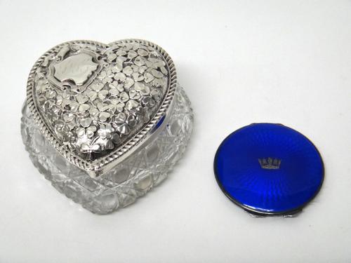 A silver lidded, faceted glass heart shaped trinket box, the cover embossed with shamrocks within a gadrooned border, Chester probably 1905 and a lady