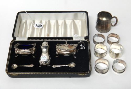Silver, comprising; a three piece condiment set, comprising; a mustard pot, a salt and a pepperette, Birmingham 1955, two condiment spoons, Birmingham
