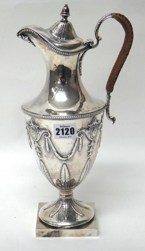 A Victorian Scottish silver claret jug, of Adam style form, decorated with beaded rims, with a rush woven handle and on a square base, in the 18th cen