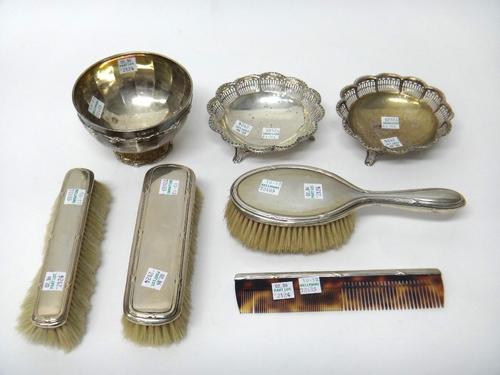 Silver, comprising; a bowl of circular form, having panelled decoration within scrolled borders, London 1921 and a pair of bonbon dishes, each of shap