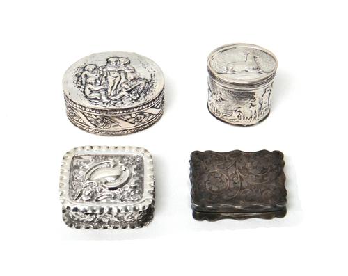 A silver shaped rectangular hinge lidded pill box, with feathered scroll engraved decoration, Chester 1904, a silver hinge lidded rectangular box, wit