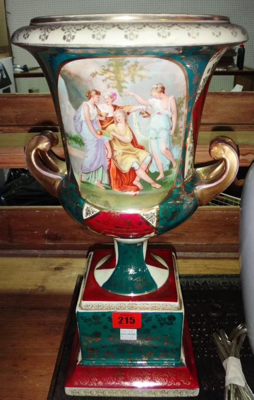 A Vienna style porcelain two handled urn, 20th century, decorated with gilt flowers against burgundy, green and cream panels, beehive mark to base, 39