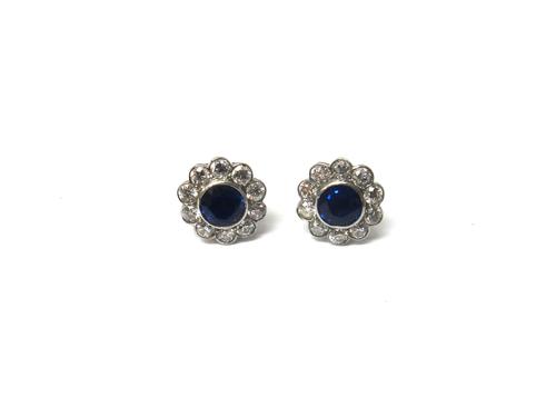 A pair of sapphire and diamond set cluster earstuds, each collet set with a circular cut sapphire at the centre, in a surround of ten circular cut dia