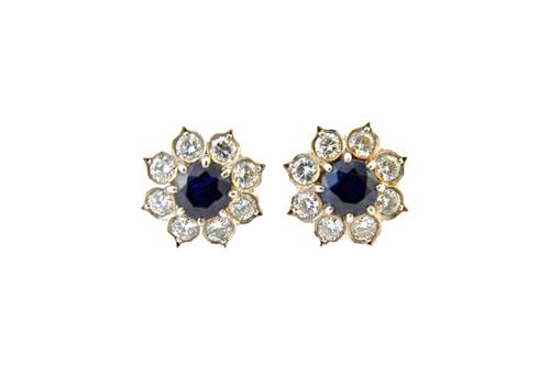 A pair of sapphire and diamond set nine stone cluster earstuds, each claw set with the circular cut sapphire at the centre, in a surround of eight cir