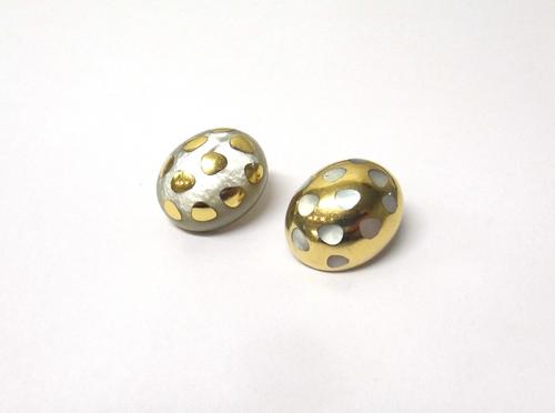 Two gold and mother of pearl earclips, each of oval form, in a differing abstract design, detailed 750, gross weight 20 gms.