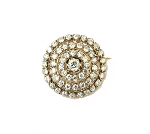 A diamond set pendant brooch, designed as a target, mounted with the principal circular cut diamond at the centre, in a stepped three row surround fur