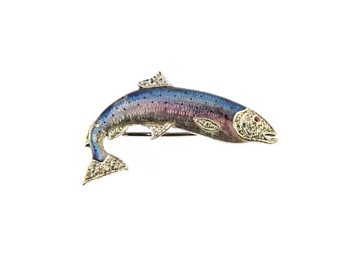 A white gold, enamelled and diamond set brooch, designed as a fish, the body enamelled, otherwise mounted with circular cut diamonds and with a ruby s