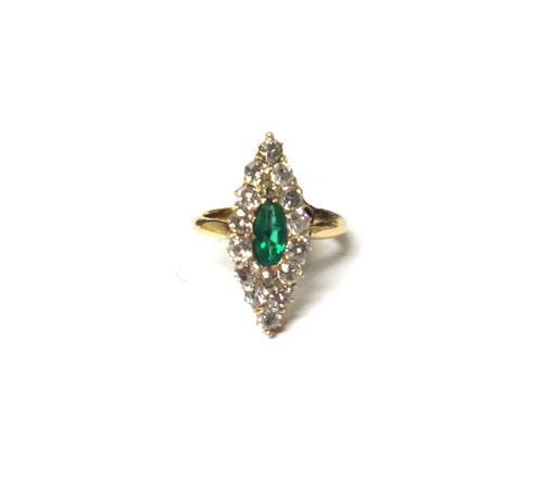 A gold, emerald and diamond set marquise shaped cluster ring, mounted with a marquise shaped emerald at the centre and otherwise mounted with cushion