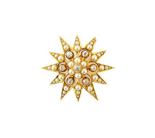 A gold, diamond and seed pearl set pendant brooch, designed as a starburst, mounted with a cushion shaped diamond at the centre, in a surround of six