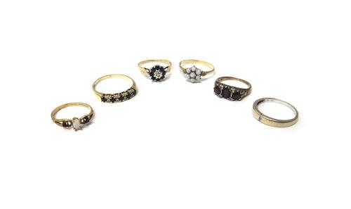 A 9ct gold, sapphire and diamond set nine stone cluster ring, a 9ct gold, sapphire and diamond set half hoop ring, a 9ct gold and opal set cluster rin
