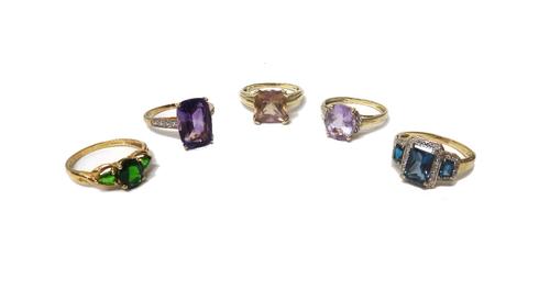 A 9ct gold ring, claw set with a cushion shaped amethyst between diamond set four stone shoulders, two 9ct gold, diamond and coloured gemstone set rin