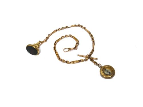 A gold watch Albert chain, in a twisted bar and knot link design, fitted with a gold T bar, two gold swivels, a compass pendant fob and with a 9ct gol