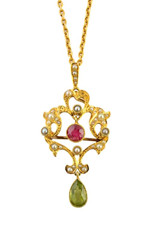 A gold, peridot, pink tourmaline and seed pearl set pendant brooch, in a scroll pierced openwork design, mounted with the pear shaped peridot to the d