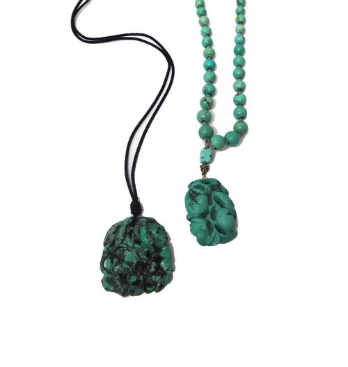 A carved turquoise matrix necklace, probably Chinese, the front with a pendant carved and pierced with fruit and foliate motifs, on a graduated turquo