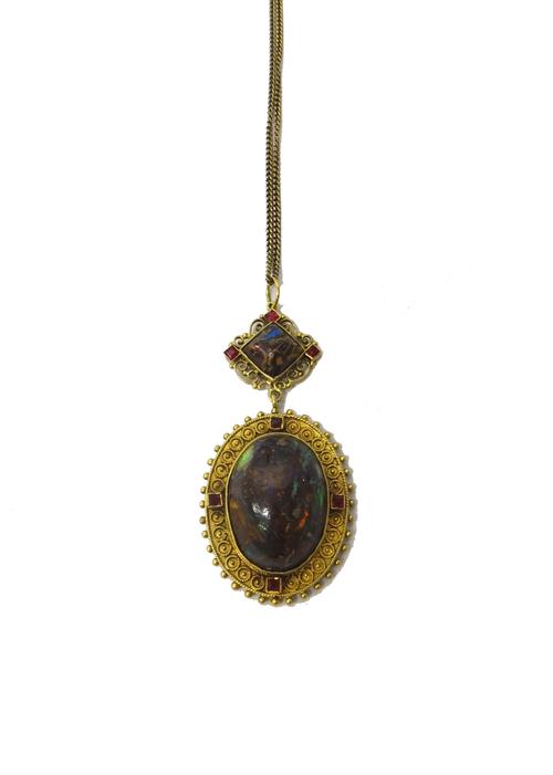 A gilt metal mounted, wood opal set pendant, the principal oval drop mounted with a central oval wood opal in a bead and granulation work decorated ov