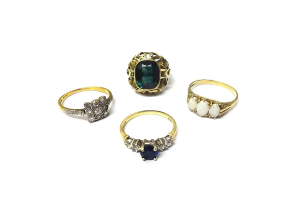 A gold and diamond set nine stone cluster ring, mounted with cushion shaped diamonds, between diamond set three stone shoulders, a gold, blue and colo