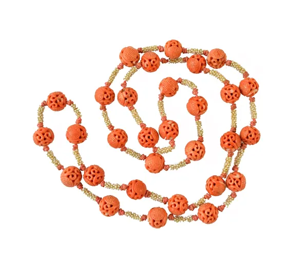 A Chinese single row necklace of carved coral beads, each bead with carved and pierced decoration and with seed pearls at intervals, probably Cantones