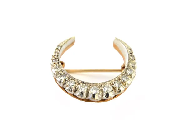 A 9ct two colour gold and diamond set brooch, designed as a crescent mounted with a row of circular cut diamonds graduating in size to the centre ston