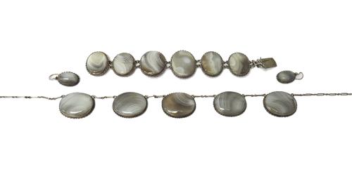 A banded grey agate suite of jewellery, comprising; a five stone necklace, a five stone bracelet and a pair of single stone earrings, the tops having