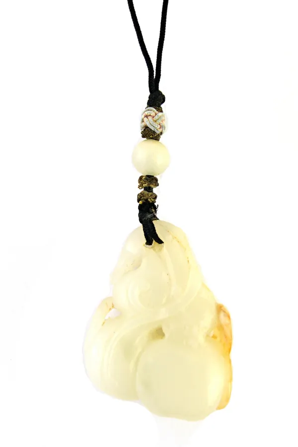 A carved jade pendant, probably Chinese 20th century, designed as fruit and foliage, fitted to a black textile cord.  Illustrated