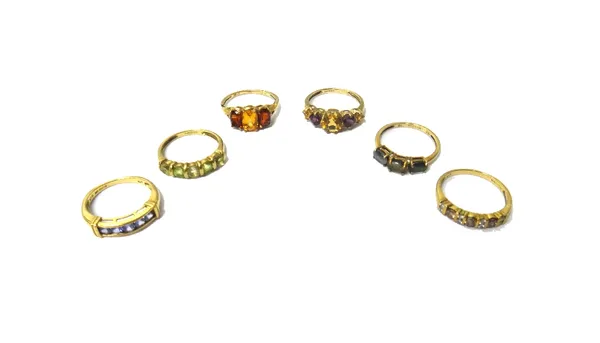 A 9ct gold, garnet and citrine set three stone ring and five further 9ct gold and gemstone set rings, in a variety of designs.