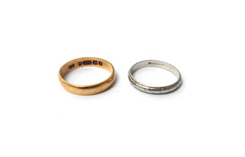 A platinum wedding ring, ring size M, weight 2.5 gms and a 9ct gold plain wedding ring, ring size N, weight 1.7 gms.