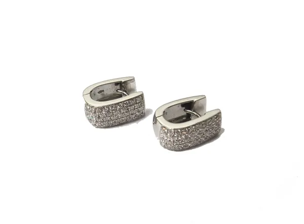 A pair of 18ct white gold and diamond set earclips, each in a curbed design and mounted with five rows of small circular cut diamonds, detailed 750, g