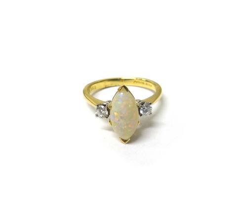 An 18ct gold, opal and diamond set three stone ring, mounted with the marquise shaped opal at the the centre, between two circular cut diamonds, ring