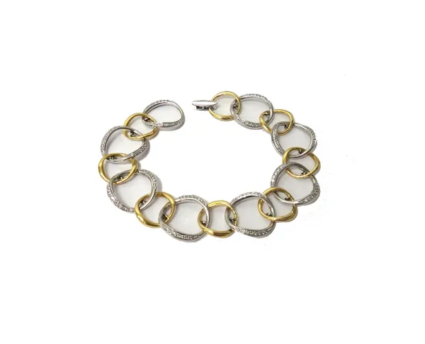 An 18ct two colour gold and diamond set bracelet, designed as a row of diamond set larger white gold openwork links, alternating with smaller yellow g