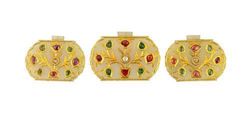 Three gem set jade pendants, North India, 19th century, each of cusped form, with a suspension fitting at the top, the gem set floral motifs centred b