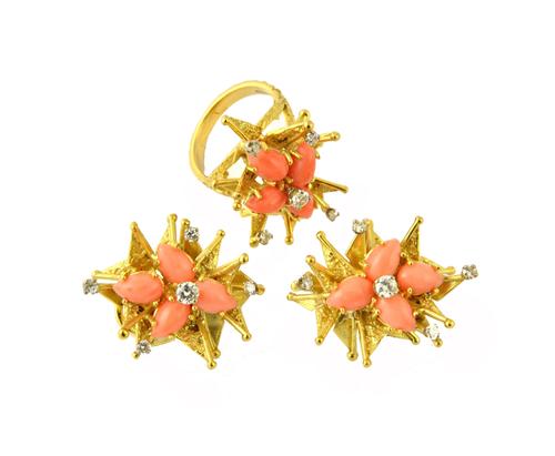 An 18ct gold, diamond and coral set ring, in an abstract design, having a textured finish, mounted with the principal circular cut diamond at the cent