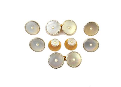 A gentleman's gold and platinum, mother of pearl and seed pearl set dress set, comprising; four buttons, a pair of cufflinks and a pair of dress studs